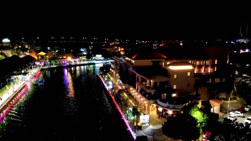 Malacca river and skyline at night, aerial view from drone