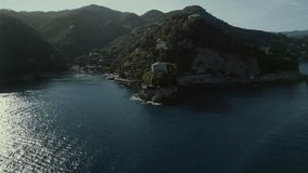 drone video of the coastline in italy, in the frame the blue sea, ships, yachts, rocks, summer holidays