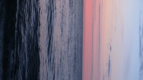 VERTICAL VIDEO, Colorful sky at sunset over the sea horizon of the Baltic Sea