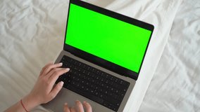 Close up smart caucasian teenage girl female hands using laptop green screen Chroma Key. Woman typing on the keyboard using touchscreen. Online shopping, browsing internet, messaging, social media