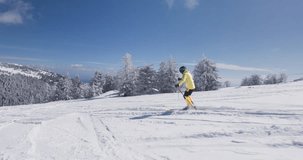 Experienced professional skier skiing on unprepared slope on a sunny winter day with fresh powder. Recorded at 120fps. Ski run 01 clip 3 of 6.