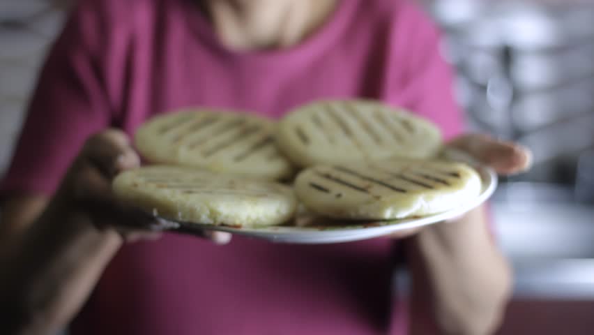 woman presents some delicious Colombian arepas in a kitchen Royalty-Free Stock Footage #1107043267