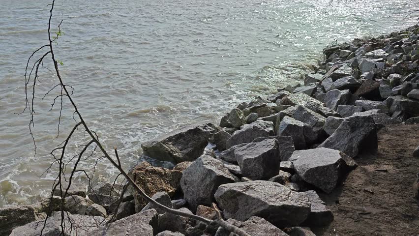 high-tide of seawater splashing onto the rocky beach