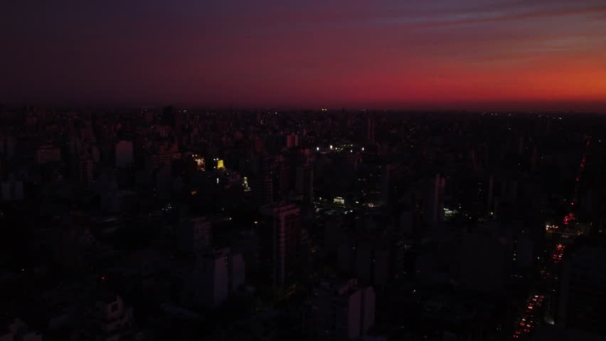 Night Buenos Aires, the sun has almost set, pink sky and pink houses