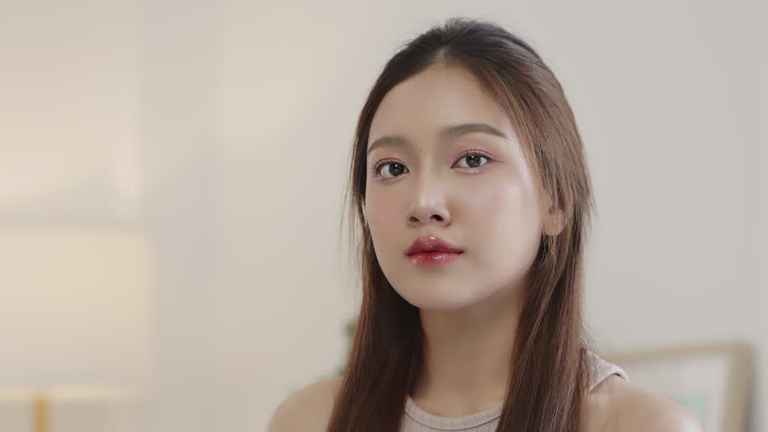 Beauty Asian woman with natural look make up lookin and smiling to camera.