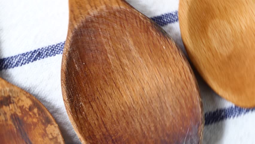 wooden spoons rotate on a board. 4k video.Kitchen utensils
