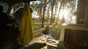 POV first person view from inside of camper van to beautiful forest with smoked campfire in camping. friends on picnic outdoors in autumn evening pine woods. car travel journey and vacation in nature - Powered by Shutterstock - Get 15% off with code: PIKWIZARD15