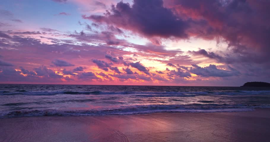 aerial view cloud moving in purple sky during stunning sunset.
at sunset, the sky lit up with a lavender hue, 
creating a mesmerizing sight of purple clouds reflecting off the surface of the sea.
 Royalty-Free Stock Footage #1107062875
