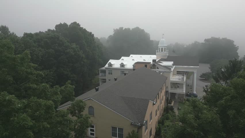 Foggy aerial flies low over roof top of Lambuth Inn on Lake Junaluska