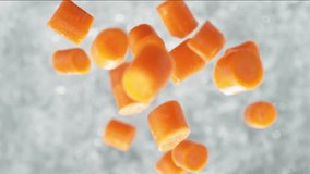 Carrots Falling into Pot of Boiling Water Making a Splash in Slow Motion - Table Top View - Powered by Shutterstock - Get 15% off with code: PIKWIZARD15