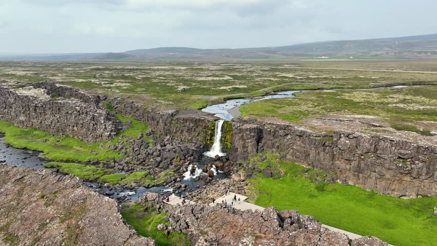 Aerial view of Oxararfoss waterfall, inside the Thingvellir National Park, Iceland. Royalty-Free Stock Footage #1107071357