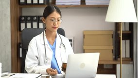 Caring asian therapist conducts video consultation, communicates with patient via an online conference, uses laptop, diagnoses, recommended and prescribed medications, and also answers questions.