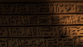 Light spot moving on ancient egypt hieroglyphics carving on wall of temple. Vertical video