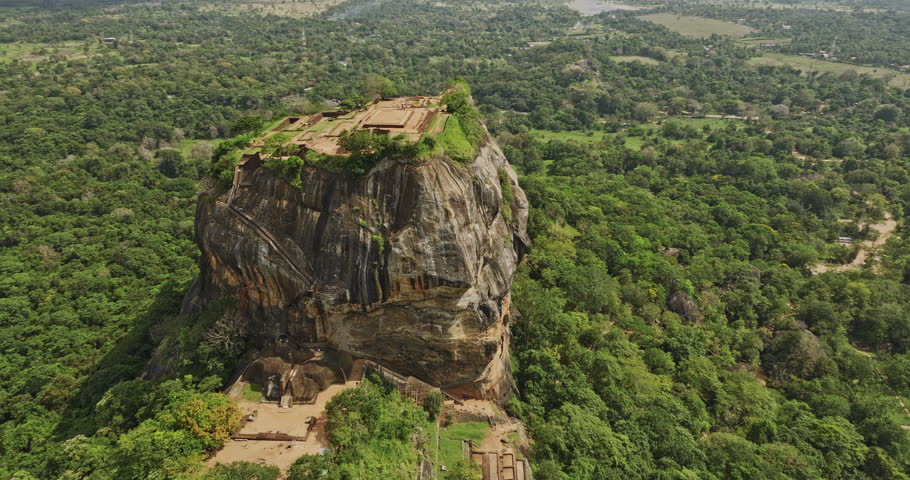 Sigiriya Sri Lanka Aerial v10 drone fly around Sigiriya rock capturing intricate details of ruins, rock fortress, royal residence and surrounding forest landscape - Shot with Mavic 3 Cine - April 2023