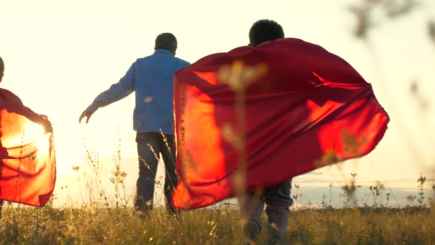 Father children playing game pretend to be superheroes. children wear red capes dream being able fly like superheroes. play together team, running working together win game. feel powerful together | Shutterstock HD Video #1107088687
