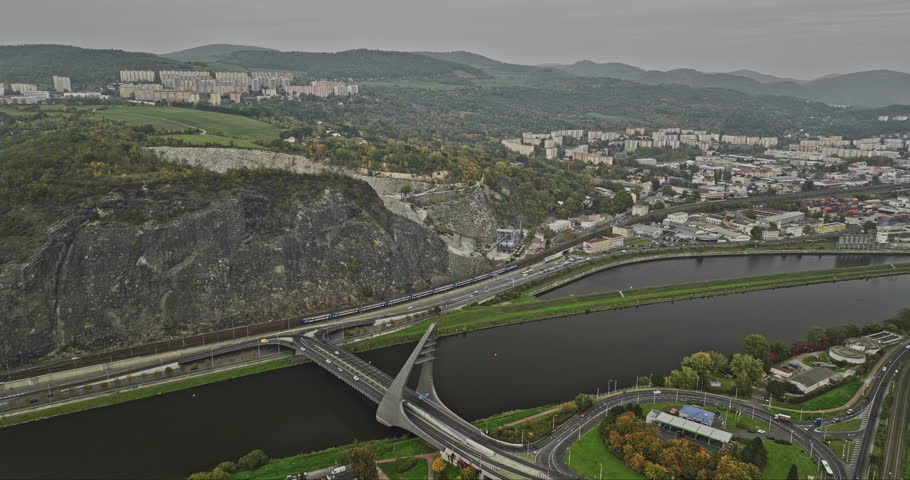 Usti nad Labem Czechia Aerial v3 flyover Elbe river across Mariansky Most bridge towards Lom Mariánská Skála quarry site, panning reveals hillside cityscape - Shot with Mavic 3 Cine - November 2022