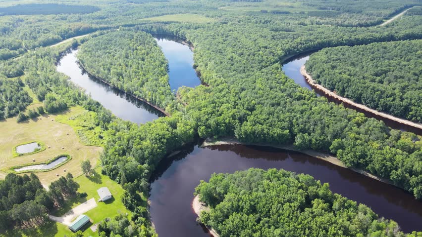 Flying over a very winding river and forest in Northern Minnesota near the border of Canada