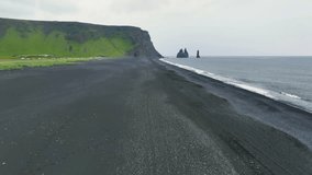 4K aerial video of Reynisfjara Black Sand Beach and rocks Reynisdrangar in Iceland