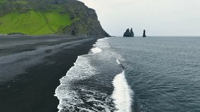 4K aerial video of Reynisfjara Black Sand Beach and rocks Reynisdrangar in Iceland - Powered by Shutterstock - Get 15% off with code: PIKWIZARD15