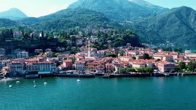 Aerial 4K footage of Menaggio old town, Como Lake. Panoramic view of Menaggio town surrounded by mountains in Lombardy, Italy