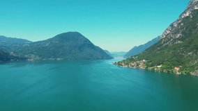 Aereal 4K drone flight footage of Lugano lake among mountains between Switzerland and Italy, beautiful panoramic landscape