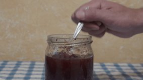 Take Out The Jam From  Jar Using A Spoon,take the jam from the jar with a spoon