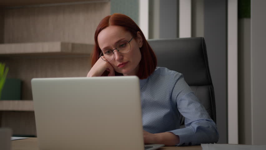 Bored sad Caucasian female girl worker tired unmotivated disinterested in online office work with laptop lazy businesswoman employee business woman lack of motivation annoyed with boredom boring job Royalty-Free Stock Footage #1107126169