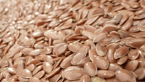 Through the probe lens, marvel at flax seeds' golden-brown hue, loaded with omega-3, fiber, and antioxidants, promoting heart health and overall well-being. Food concept. Flax Seeds background
