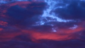 TIMELAPSE Dark blue and red sunset sky cloud background Slow motion epic storm tropical sunset dark cloud stormy. digital cinema composition background evening fast moving away. global warming concept