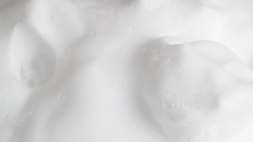 Hair foam mousse, macro. Beauty background. Close up of white cloud of hair mousse or shaving foam. Royalty-Free Stock Footage #1107134059