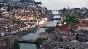 Aerial footage of various bridges over river in historic town. Tourist destination at golden hour. Zurich, Switzerland