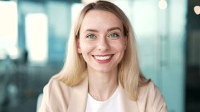 Webcam view. Close up. Businesswoman talking on a video call looking at the camera while sitting in an office. Friendly female coach speaks remotely, conducts a conversation at an online conference - Powered by Shutterstock - Get 15% off with code: PIKWIZARD15