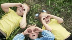 Spring fun at the playground. Happy children play together in fun circle of friendship and laughter. children gather together in a company enjoying spring weather and each other's company on the grass - Powered by Shutterstock - Get 15% off with code: PIKWIZARD15