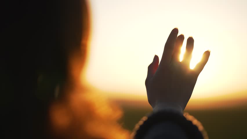 Silhouette of happy dreaming girl pulls her hand to sun.Religion helping hand. Happy girl pulls her hand.Prayer in religion.Silhouette of hand in sun.Happy girl silhouette at sunset.Freedom in nature Royalty-Free Stock Footage #1107139697