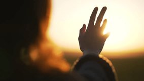 Silhouette of happy dreaming girl pulls her hand to sun.Religion helping hand. Happy girl pulls her hand.Prayer in religion.Silhouette of hand in sun.Happy girl silhouette at sunset.Freedom in nature - Powered by Shutterstock - Get 15% off with code: PIKWIZARD15