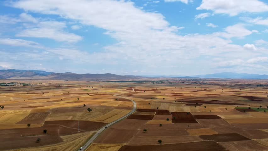 Dry summer high aerial landscape agriculture farmland.
Aerial drone view flight over different dry farming fields planted and harvested with various rural farming cultures.