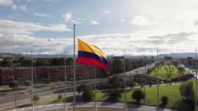 Colombian flag in the background you can see the city of Bogota, with a background road with traffic and horizontal grass, plane traveling in - Powered by Shutterstock - Get 15% off with code: PIKWIZARD15