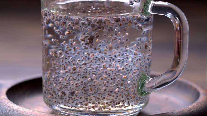 Chia seeds in warm water close-up. Preparation of chia seeds water Royalty-Free Stock Footage #1107145043