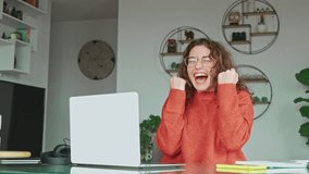 Happy girl student winner looking at laptop receiving good news in email celebrating achievement success. Excited woman winning online, getting new approved job opportunity using computer at home. - Powered by Shutterstock - Get 15% off with code: PIKWIZARD15