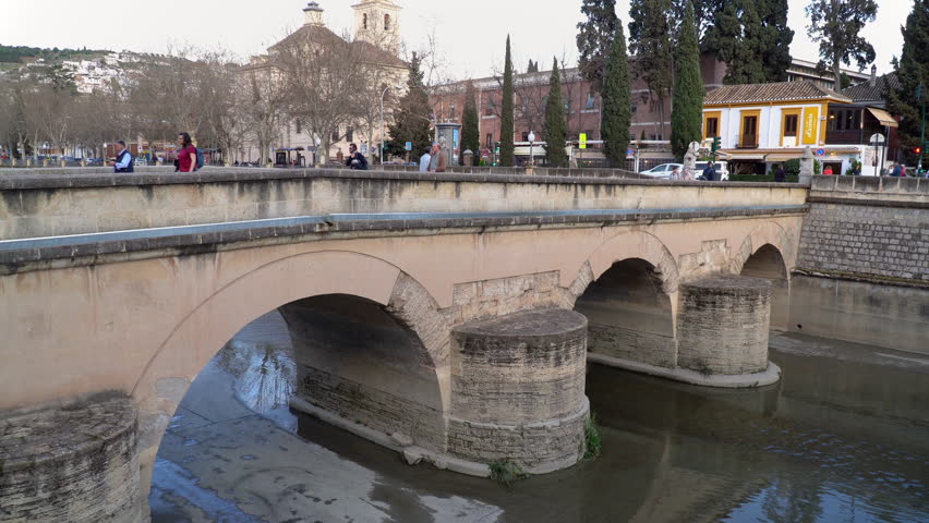 Roman Bridge, a stone arch bridge spanning the river Genil in Granada, Andalusia province, Spain