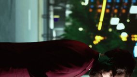 Vertical video Business person talks on phone call while he walks around town at night, enjoying urban promenade with skyscrapers and city lights. Person using smartphone to chat, looks at modern - Powered by Shutterstock - Get 15% off with code: PIKWIZARD15