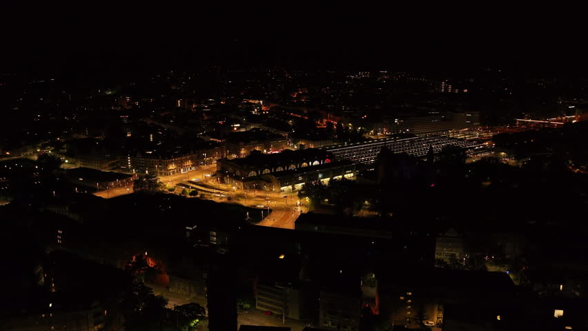 Aerial view of SBB Zurich Hauptbahnhof at night and surrounding illuminated streets. Night cityscape with main train station. Zurich, Switzerland