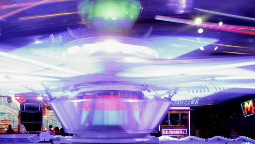 A timelapse of the lit up rides at a funfair in barcelona