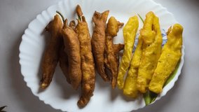 pazhamam pori or banana fry, and mulaku baji is a common snacks in kerala tea coffee shops. white background videos