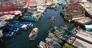 During the fishing moratorium, Guangxi Beihai Wharf was full of fishing boats，Several small boats are sailing in a port full of fishing boats