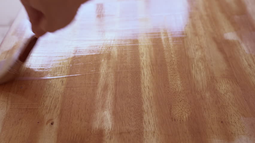 Apply clear wood stain on table with brush | Shutterstock HD Video #1107155073