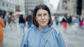 Young beautiful hispanic woman smiling confident standing in the streets of Vienna - Powered by Shutterstock - Get 15% off with code: PIKWIZARD15