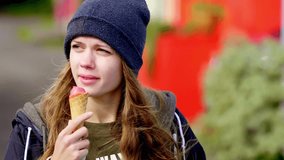 Young woman eating an icecream - slow motion clip 