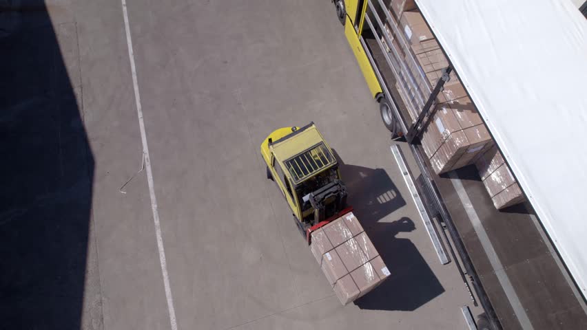Aerial video of forklift loads a truck Royalty-Free Stock Footage #1107159909