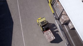 Aerial video of forklift loads a truck
